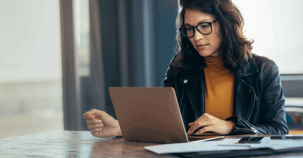 Businesswoman typing on laptop.